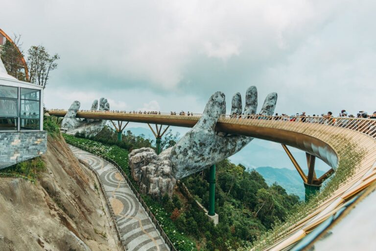 Golden Bridge held by giant hands amidst the mountains of Ba Na Hills in Da Nang, Vietnam
